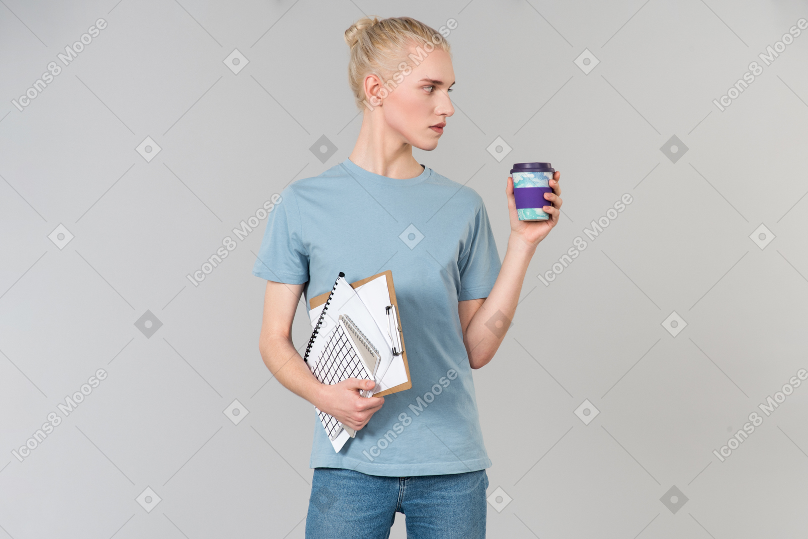 Bonito andrógino jovem em uma t-shirt azul clara e jeans azul, em seu caminho para a faculdade