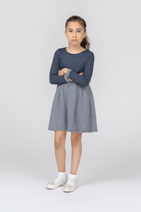 Front view of a girl pouting with folded hands