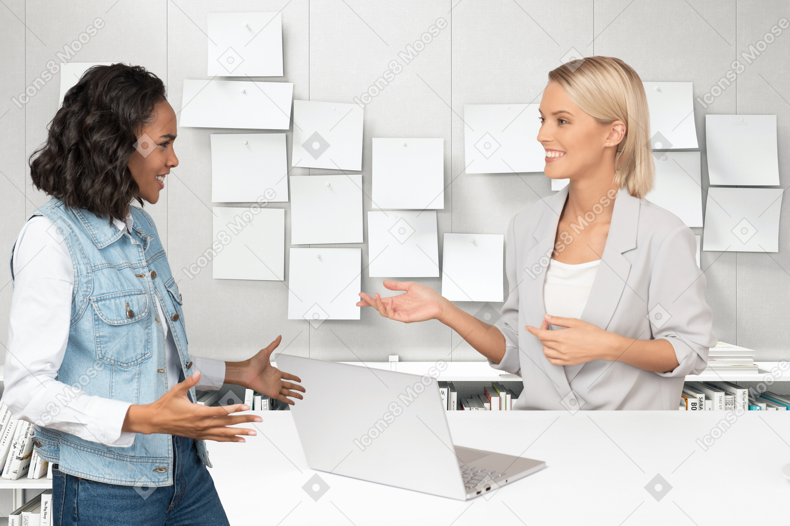 Two female colleagues discussing work