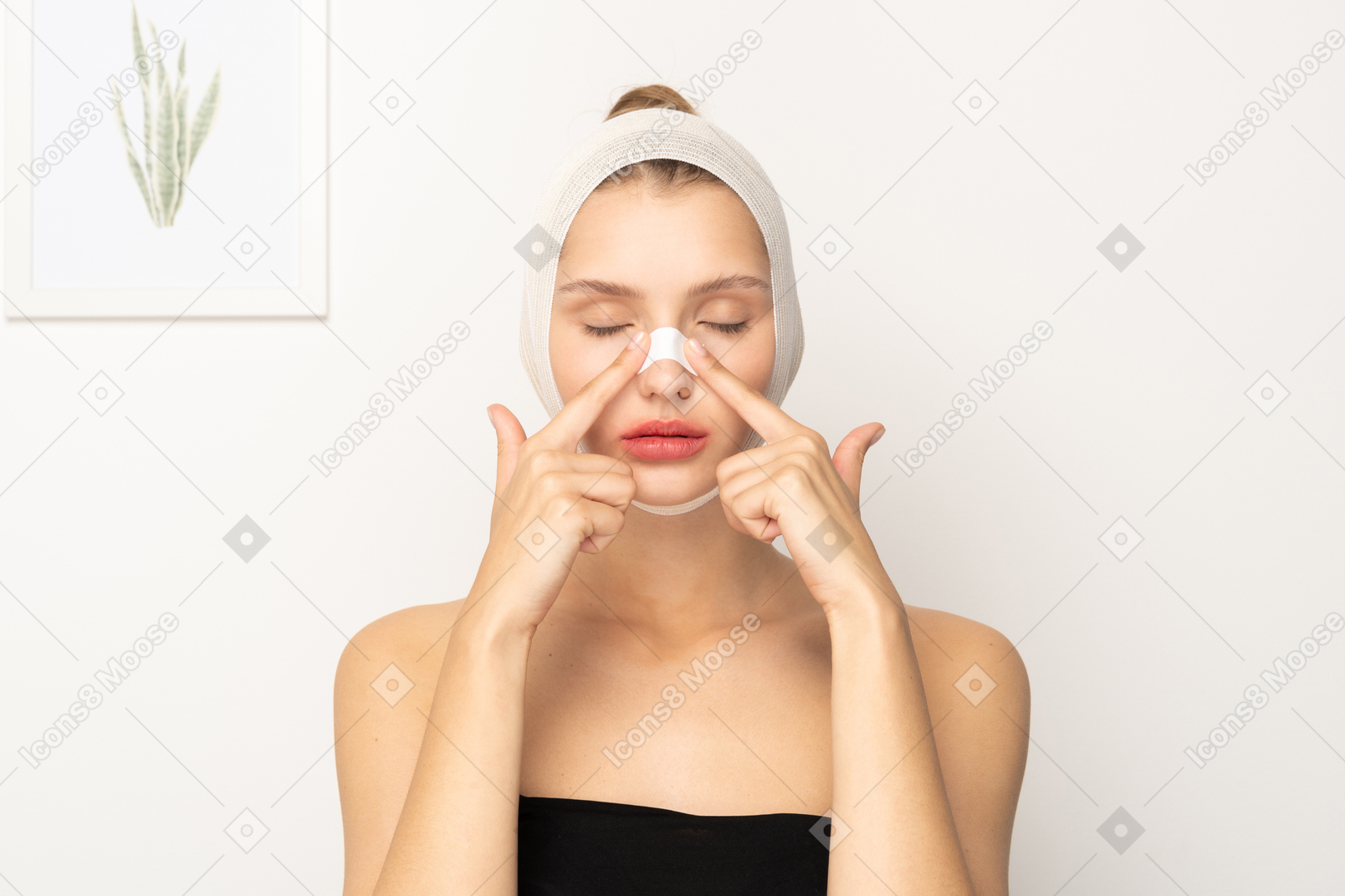Woman with head bandage placing plaster on her nose