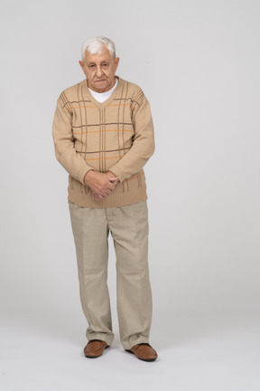 Front view of a thoughtful old man in casual clothes