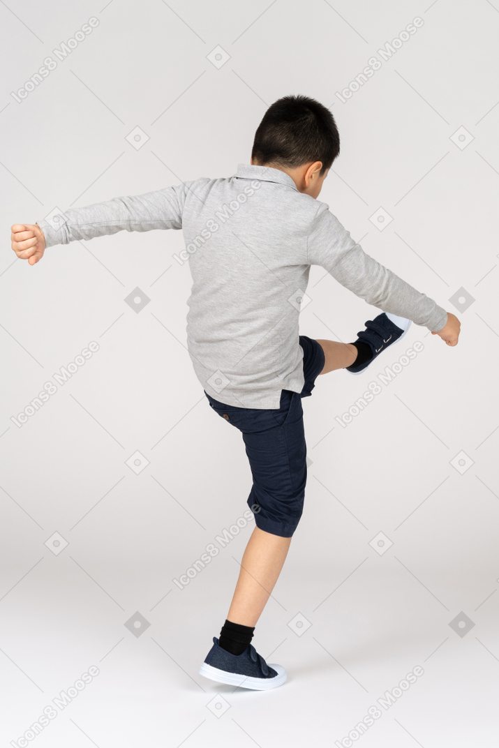 Boy kicking something
