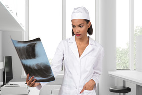 A doctor looking at an x-ray in her office