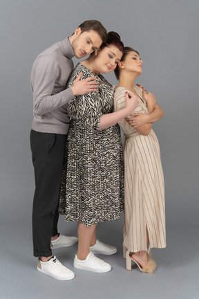 Warm embraces from two young women and one young man