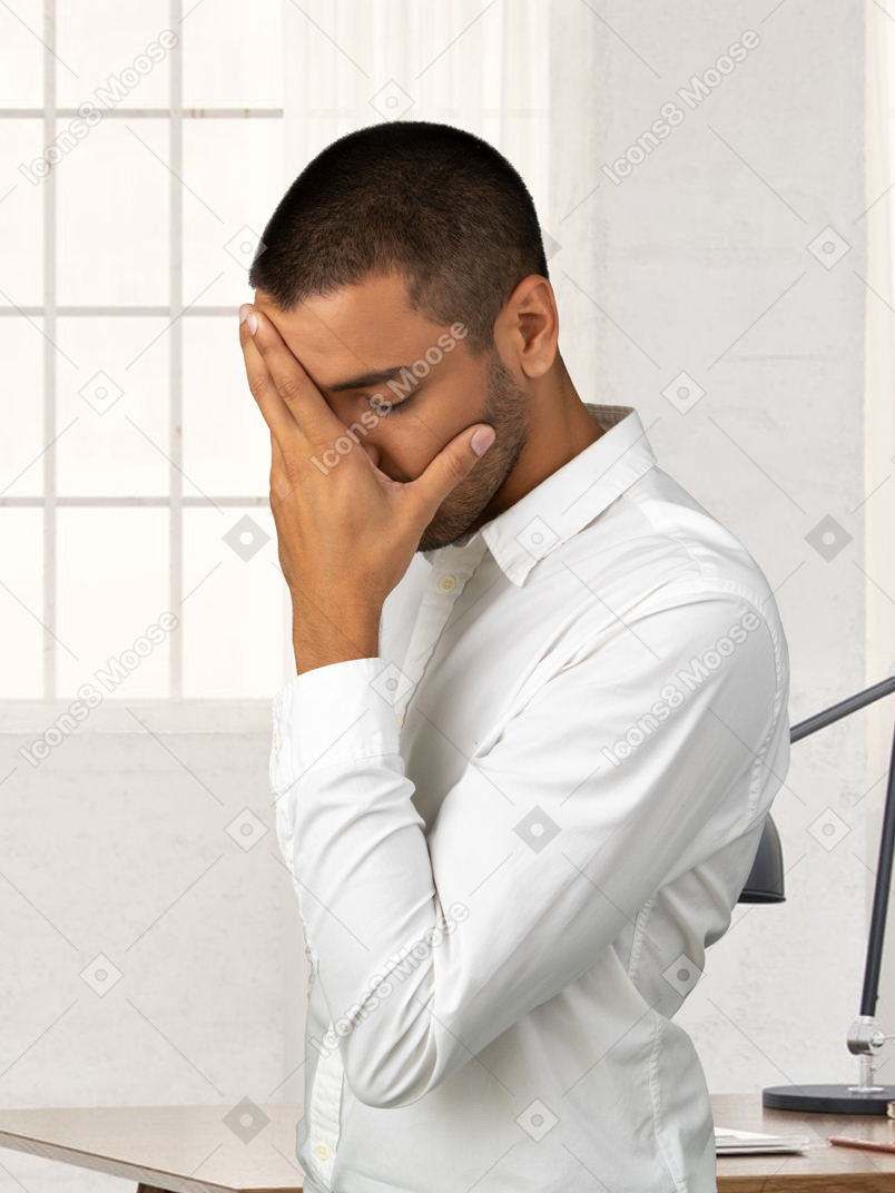 A man facepalming at the office