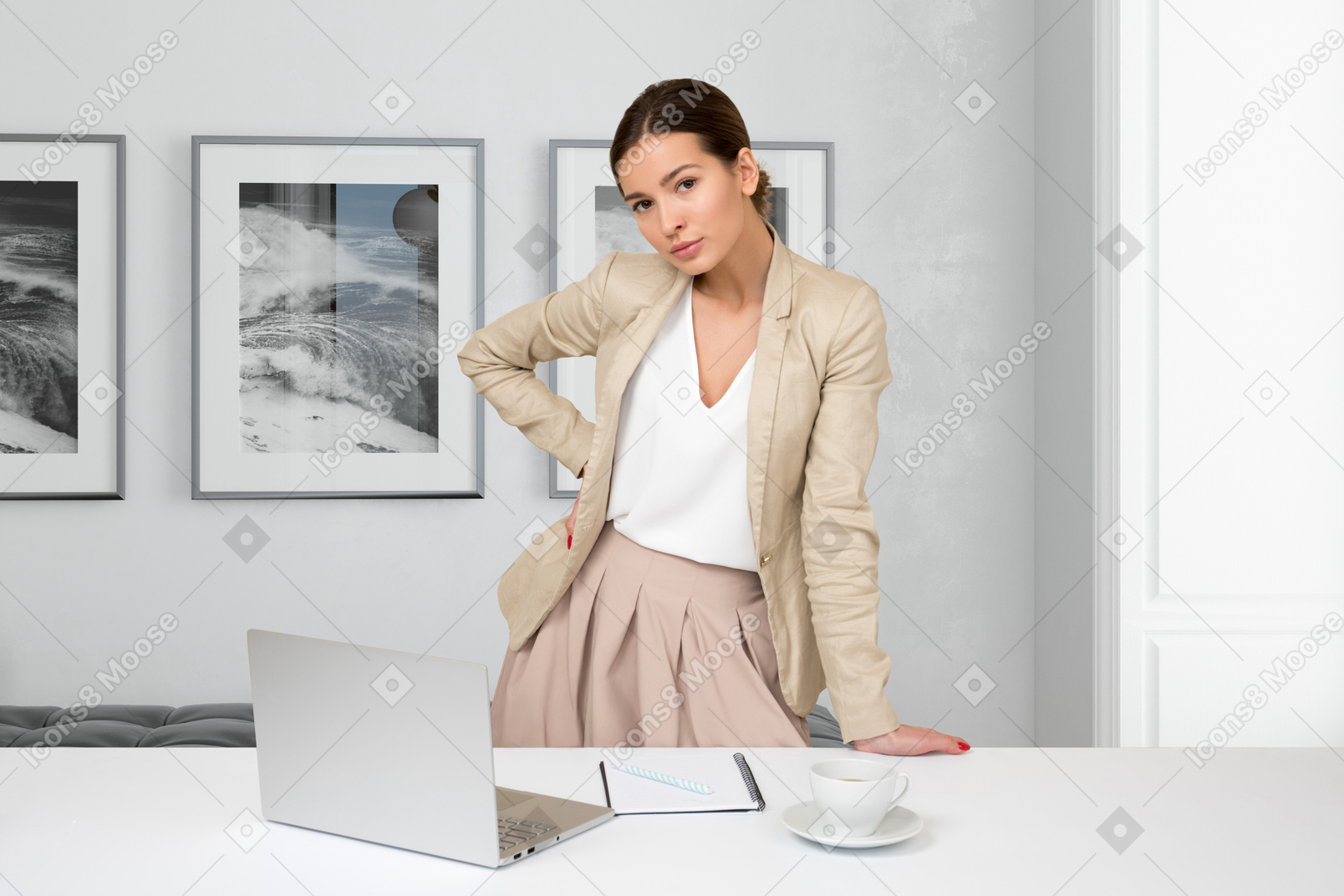 A woman standing in front of a laptop computer