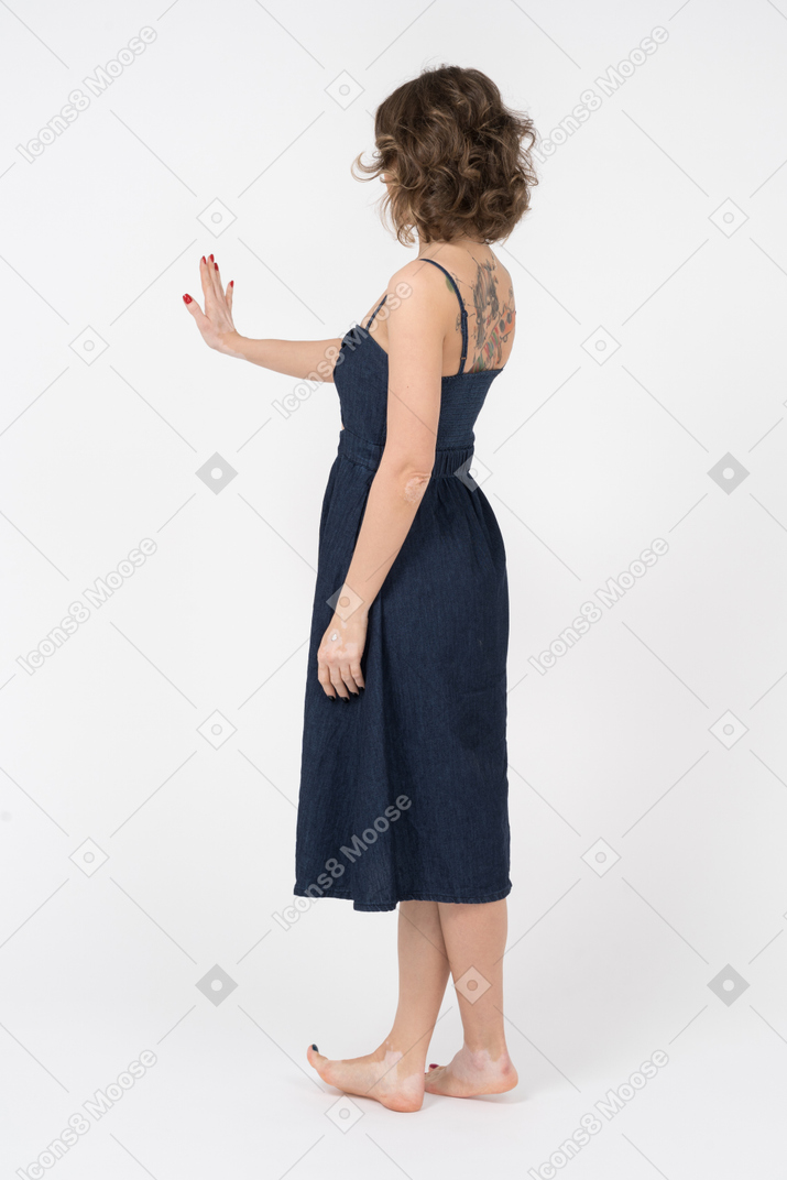 Jovem mulher tatuada mostrando uma mão parada