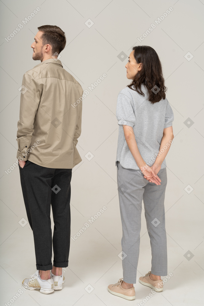Three-quarter back view of young couple standing