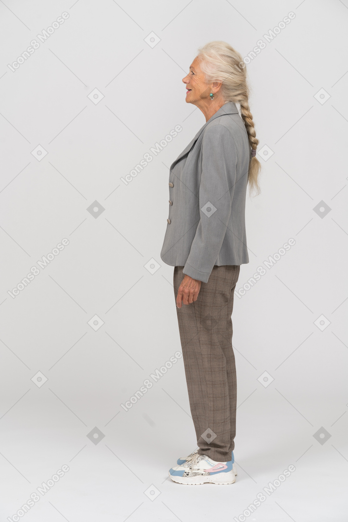 Side view of a happy old woman in suit