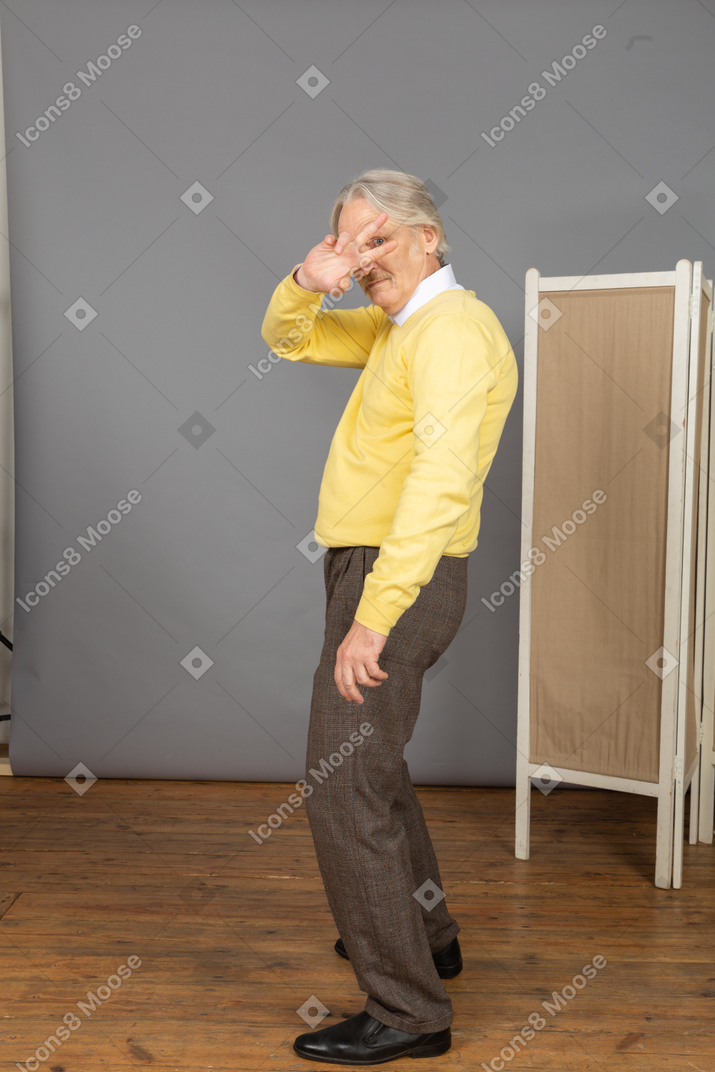 Side view of a cool dancing old man hiding his face