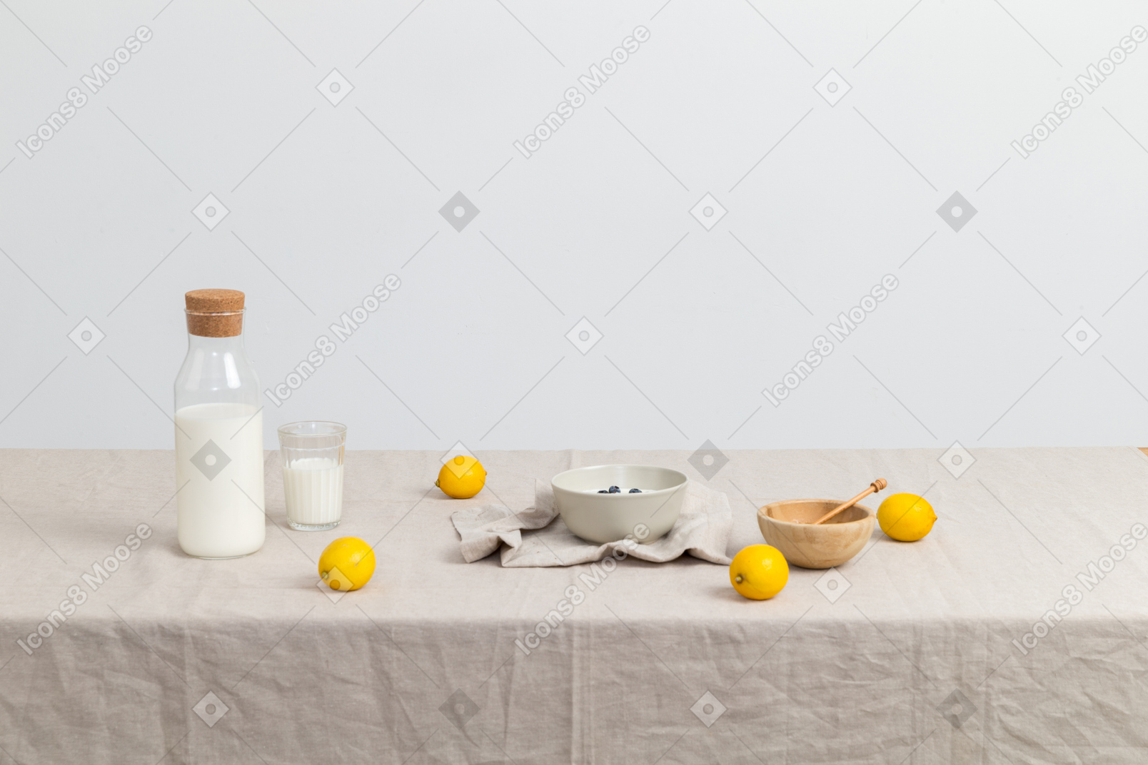 Bottle of milk, glass of milk, bowls and lemons