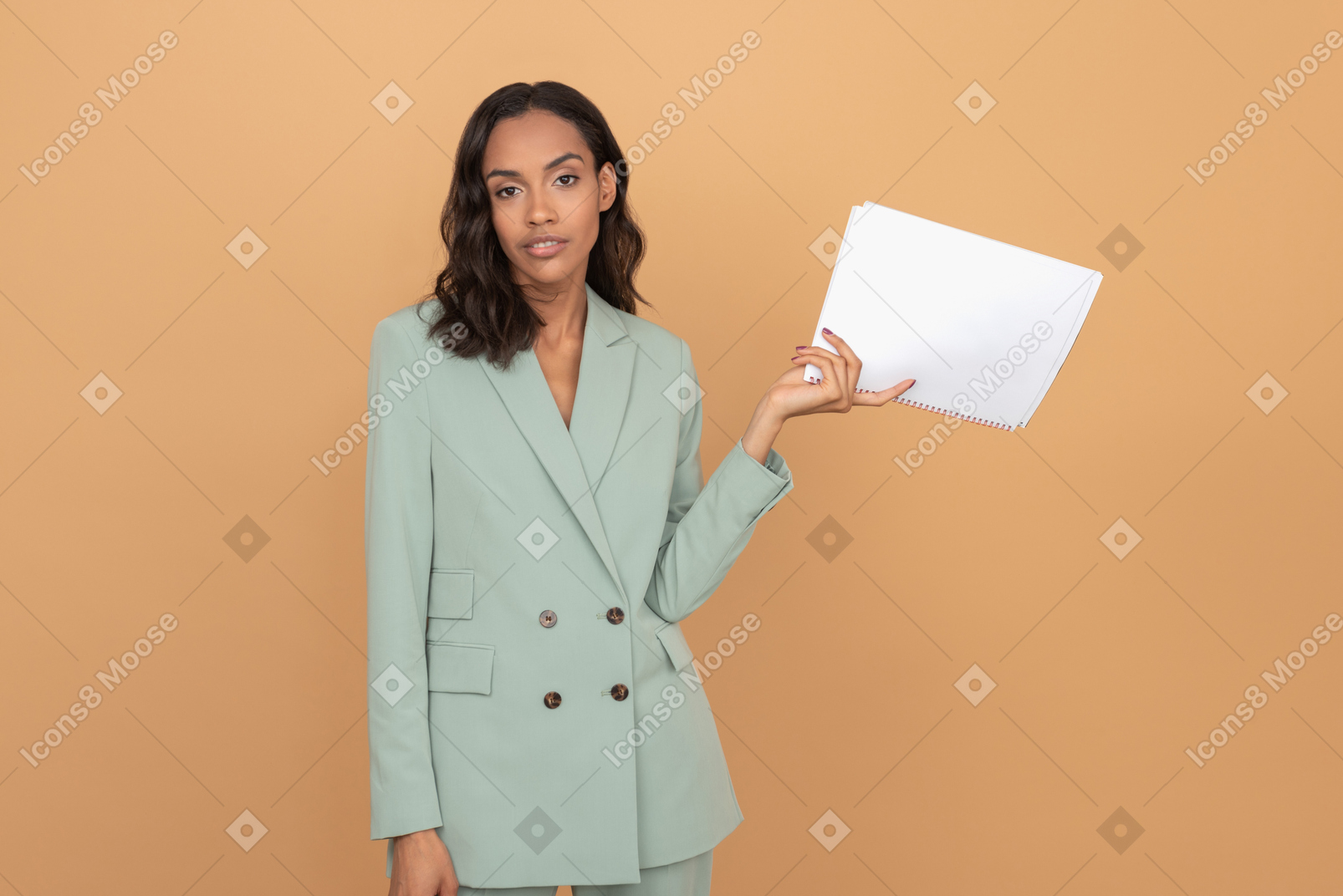 Attractive young businesswoman with serious face holding papers