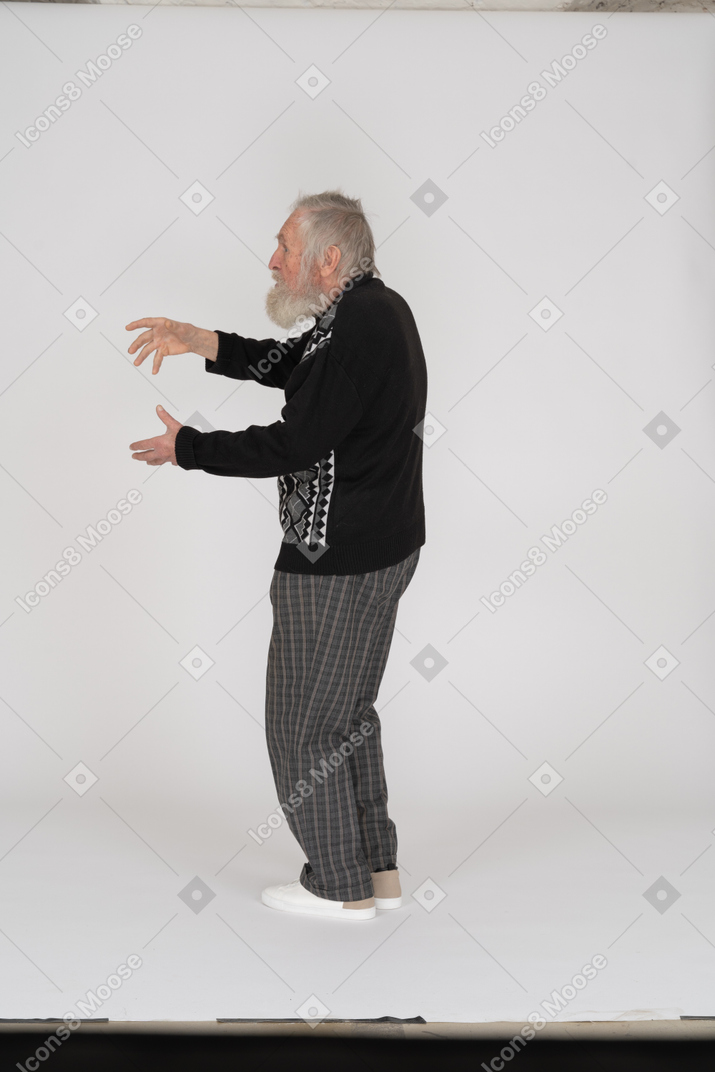 Side view of old man gesturing