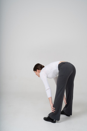 Side view of a woman bending down