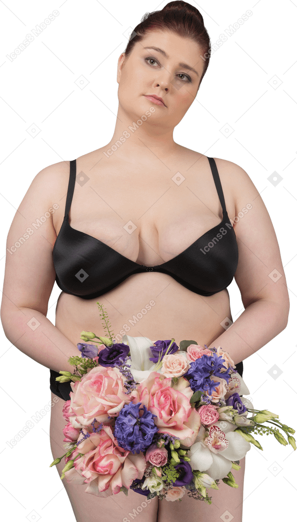 Cute plus size female posing with a flower bouquet