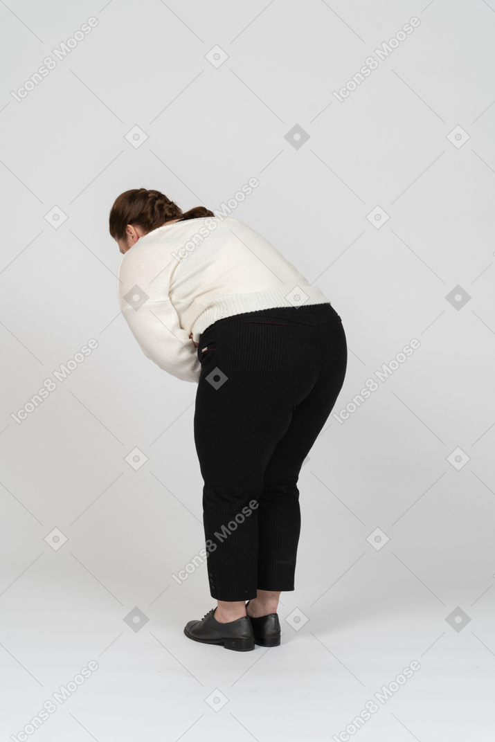 Mujer regordeta en ropa casual que sufre de dolor de estómago