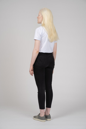 Rear view of a standing teenage girl