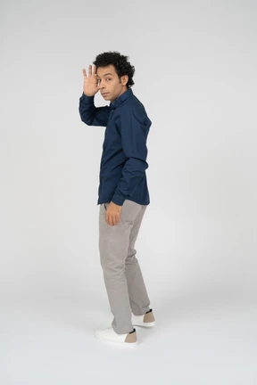Side view of a man in casual clothes gesturing