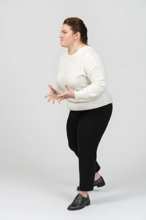 Angry plump woman in casual clothes fighting