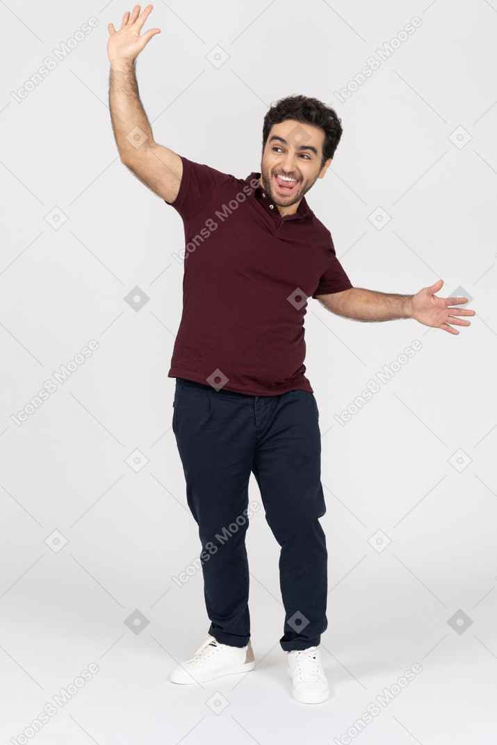 Cheerful man raising arms