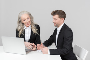 An older woman and a young man working together