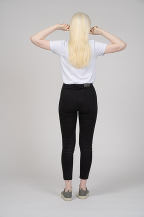 Back view of a blonde woman stretching