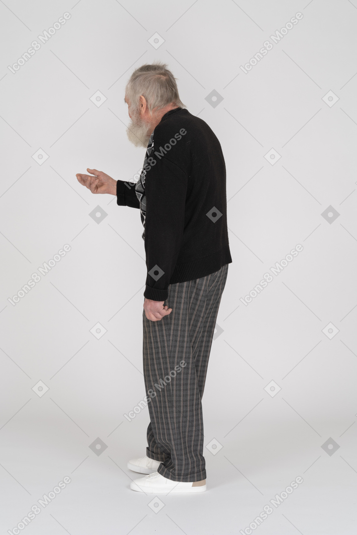 Back view of an elderly man reaching out his hand