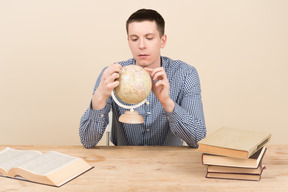 Student holding a globe