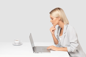 A woman sitting in front of a laptop computer