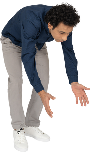 Front view of a man in casual clothes bending down