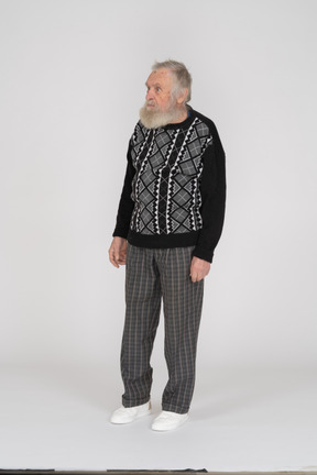 Elderly man in dark clothes standing still