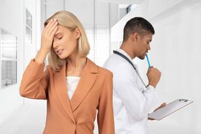 Disappointed woman standing in front of doctor