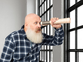 A man with a long white beard holding a roll of paper