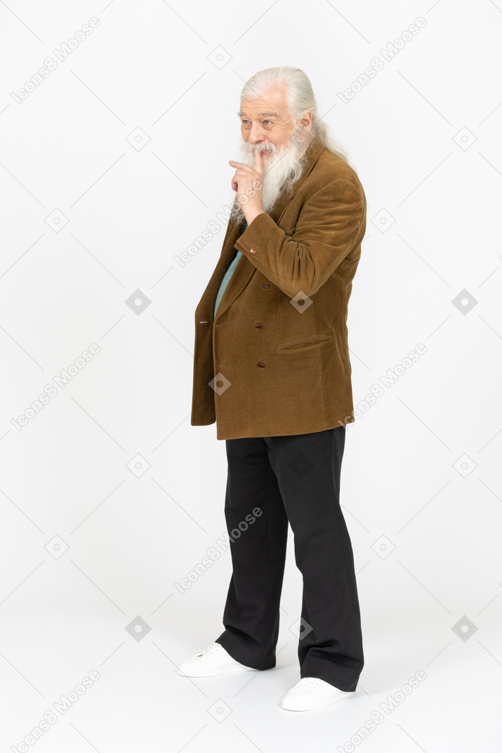Elderly man smiling and making shush gesture