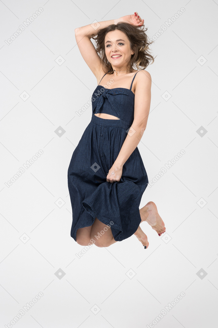 Portrait of a pleased young woman levitating