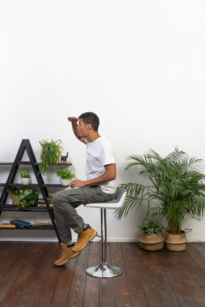 Good looking young man sitting on a chair