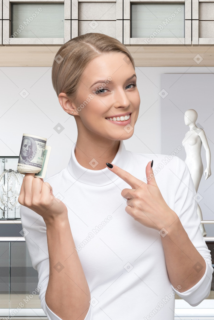 A woman holding a stack of money in her hand