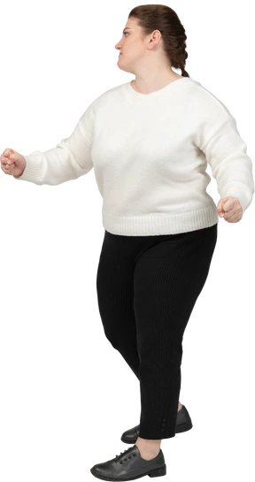 Plump woman in casual clothes dancing