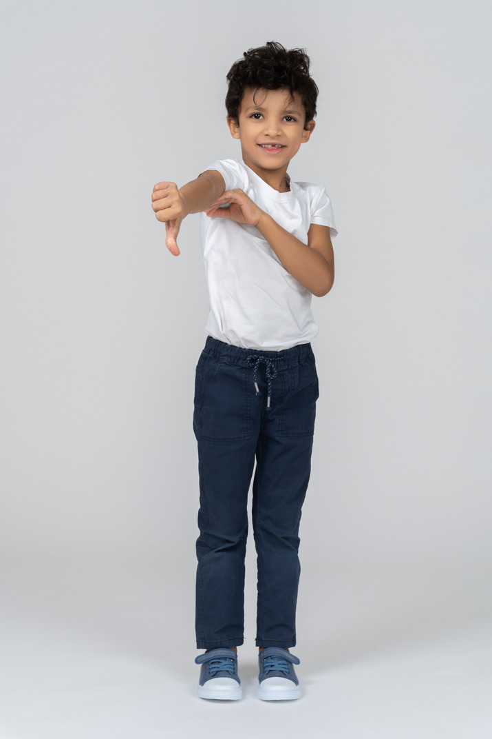 A boy showing a thumb down
