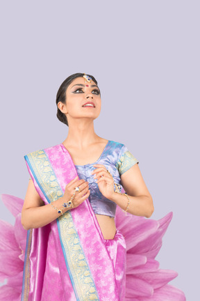 A woman in a pink and blue sari