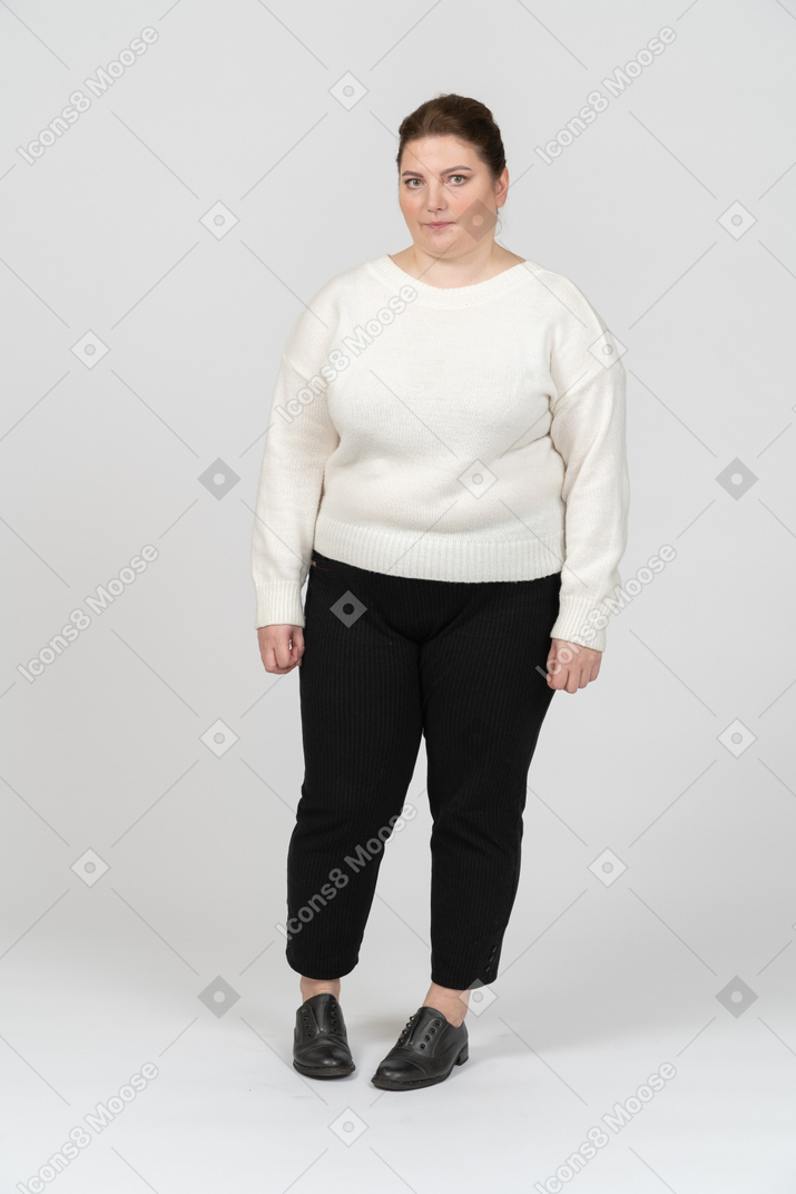 Plump woman in white sweater looking at camera