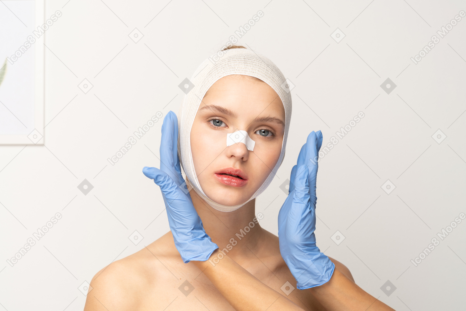 Young woman with bandaged head and hands next to her face