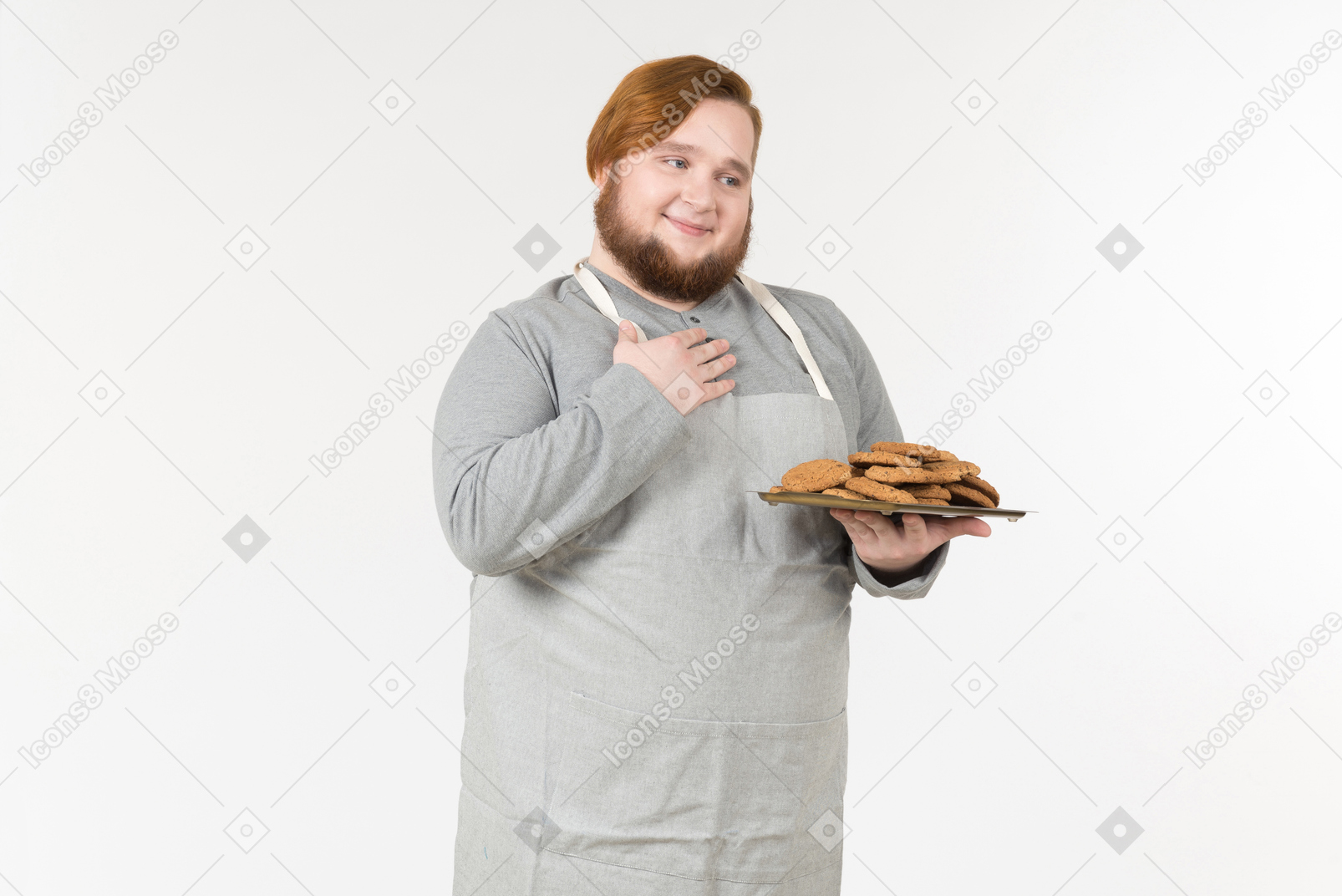 A fat baker with plate of cookies looking pleased