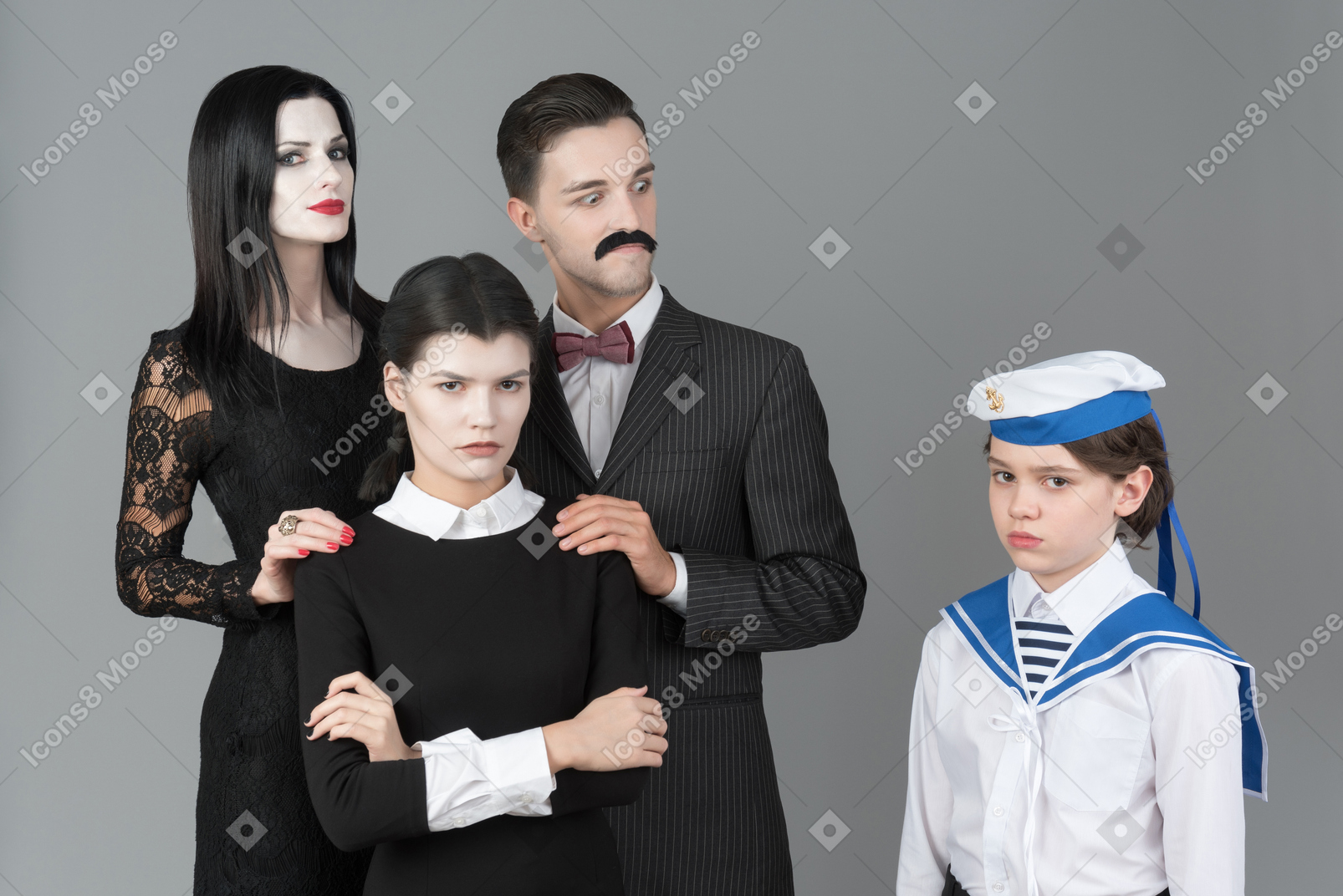 Addams family members and boy in sailor's uniform