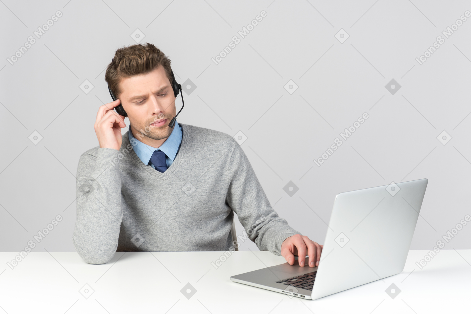 Call center agent working on computer with his eyes closed