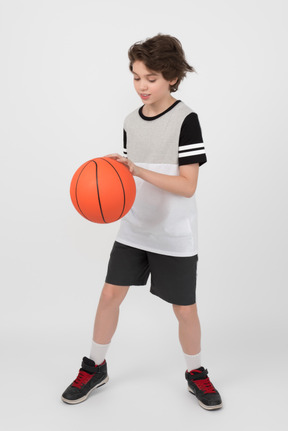 Boy is holding a basketball ball