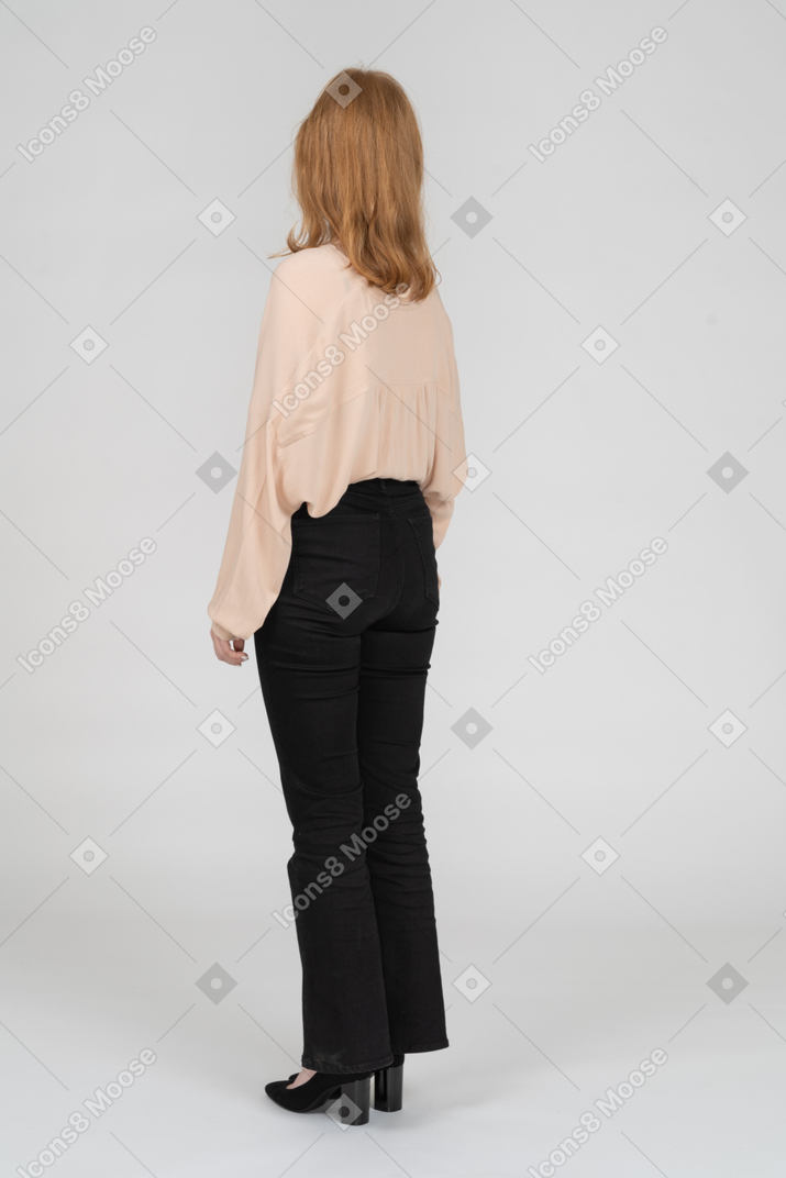 Back view of young woman standing