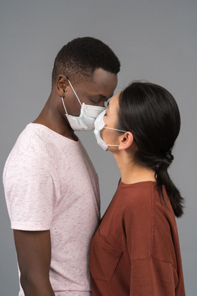 A young couple wearing face masks