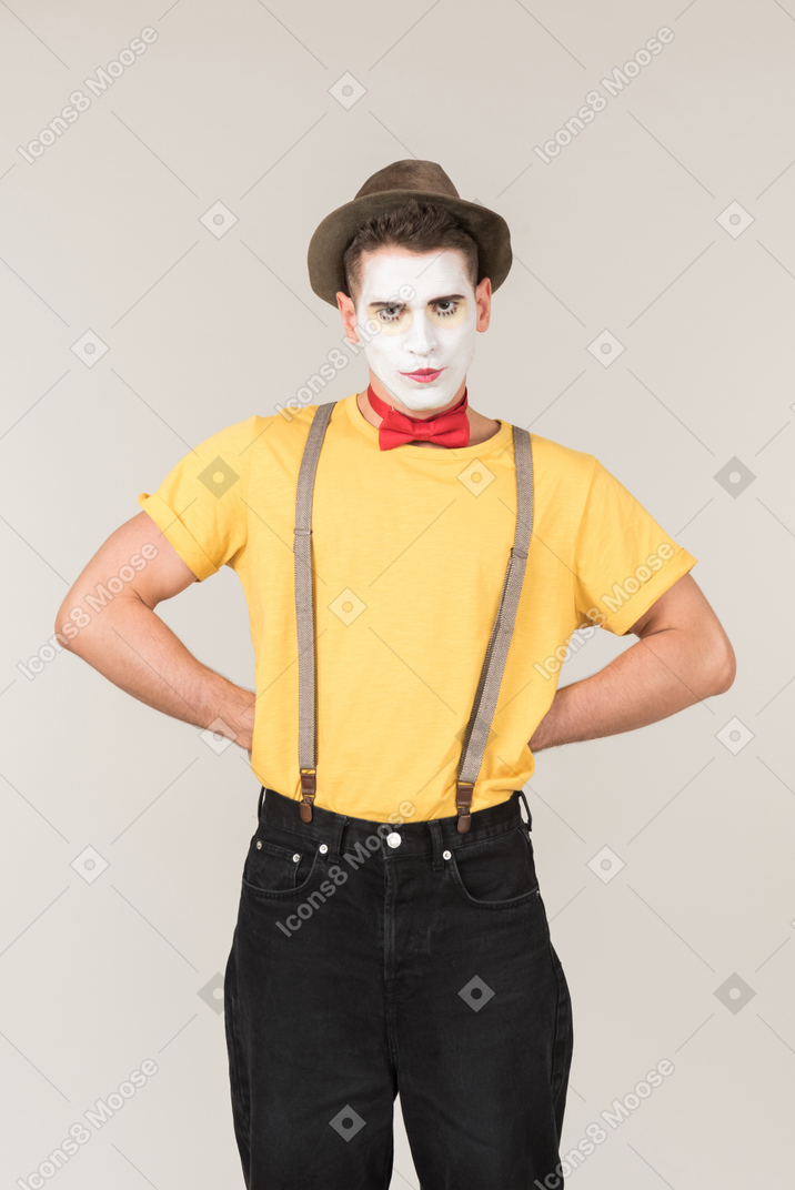 Male clown standing with hands on his hips