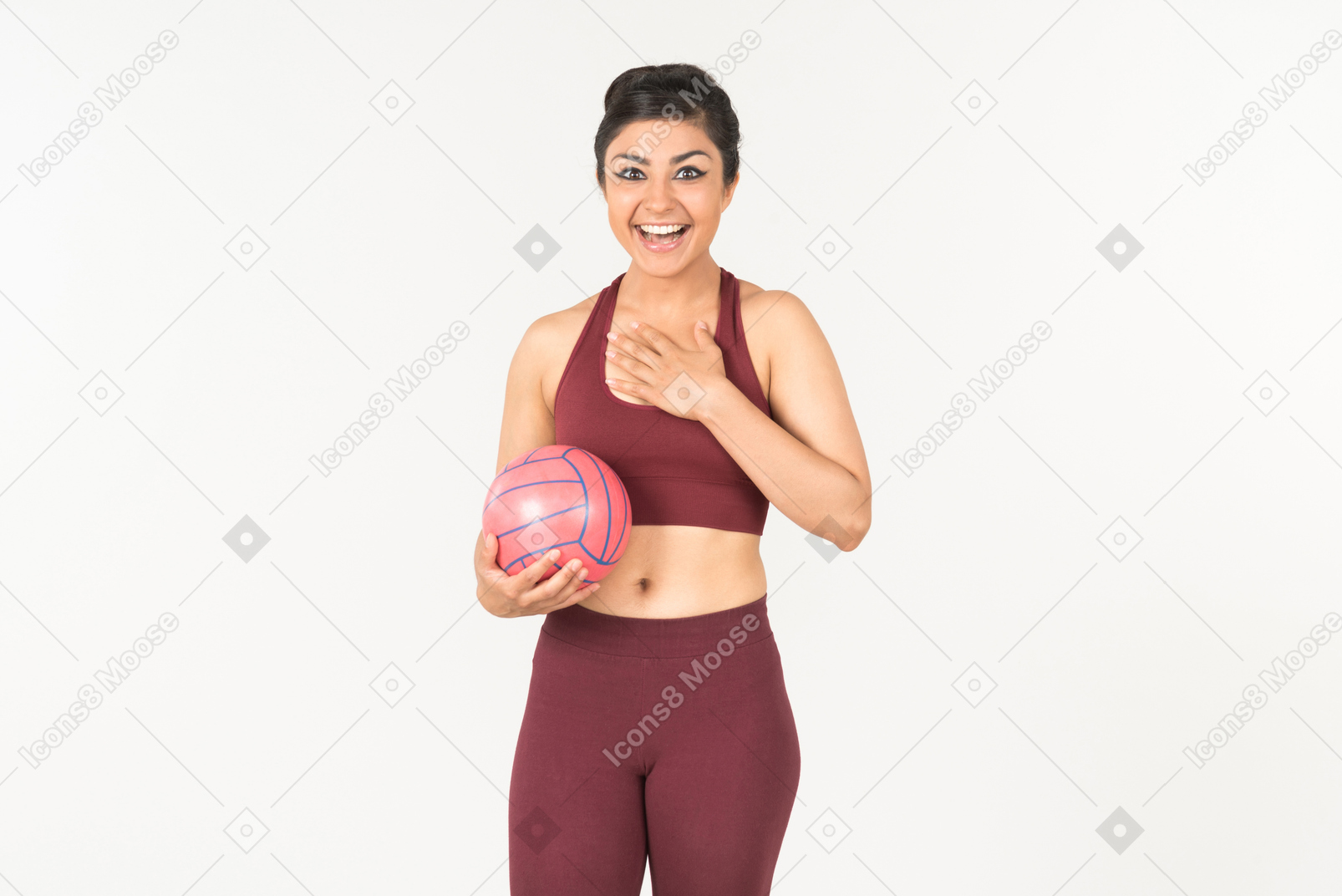 Smiling young indian woman holding pink ball